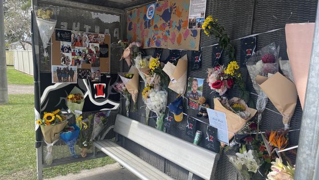 The memorial for Michael Warburton at a bus stop on Kianawah Rd where the Brisbane man was killed in a tragic hit and run crash.