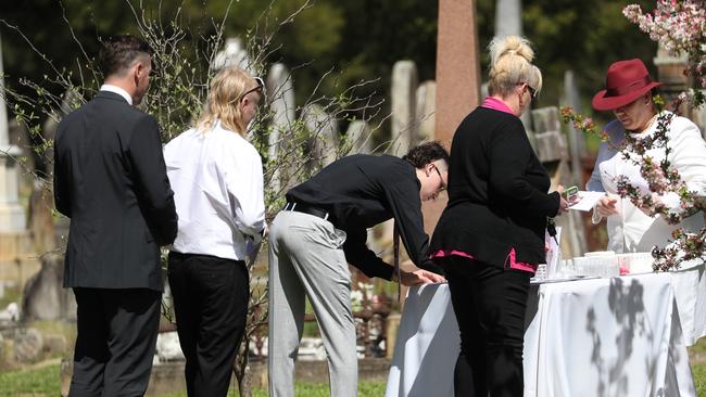 Young friends signed their attendance at the funeral. Picture: John Grainger