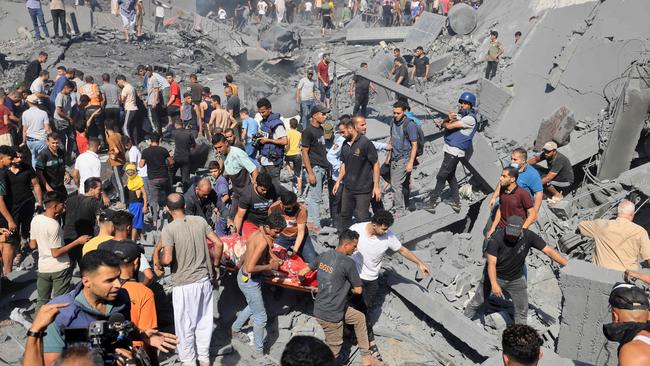 Palestinians recover the body of a person from under the rubble of buildings destroyed during Israeli bombardment, in Khan Yunis in the southern Gaza Strip. Picture: AFP