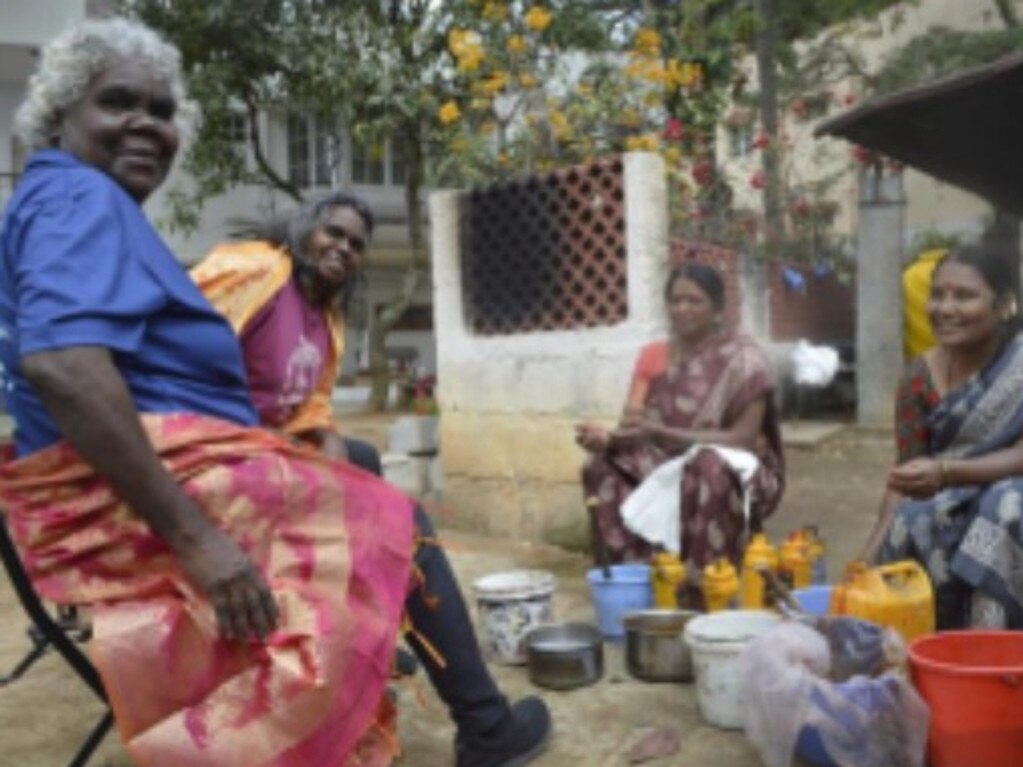 Janet Marawarr and D. Wurrkidj with colourists from Tharangini Studio, Bangalore, in 2023. Picture: Jessica Stalenberg