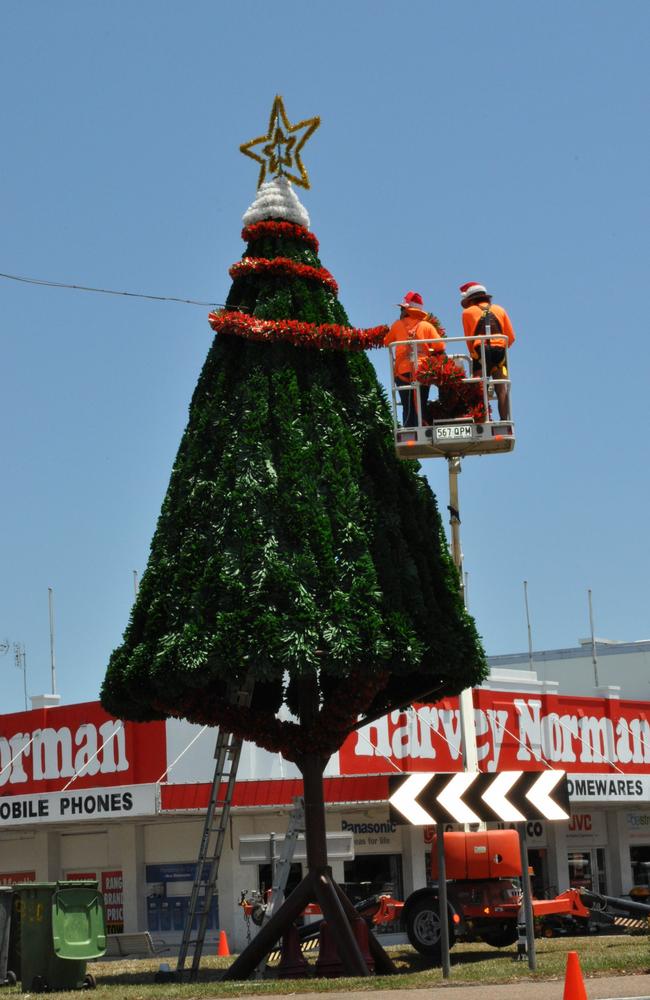 Burdekin Shire Council workers decorating the town's Christmas tree at the Queens and Edward St roundabout in 2013.