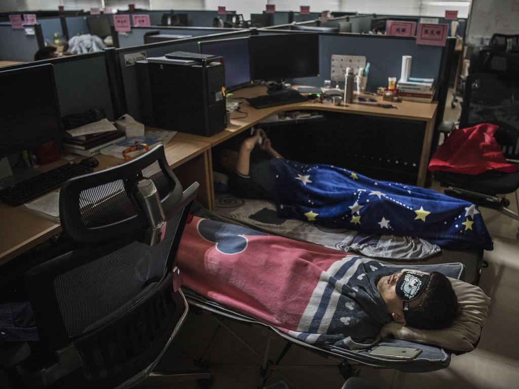 Huawei employees seen sleeping on the floor at their desks. Picture: Getty