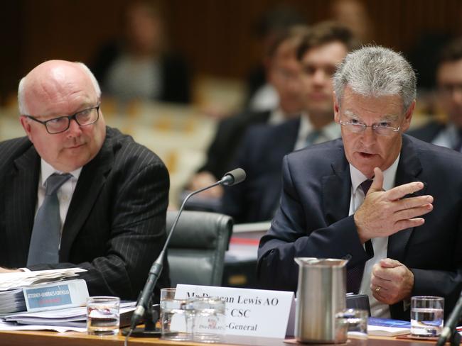 Australian Security Intelligence Organisation head Duncan Lewis (right) talks at the Senate Legal and Constitutional Affairs Legislation Committee as Attorney-General George Brandis looks on. Picture Gary Ramage