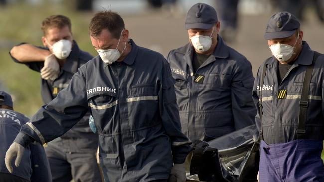 Grim task ... emergency workers carry the body of a victim at the crash site  near the village of Hrabove, eastern Ukraine.
