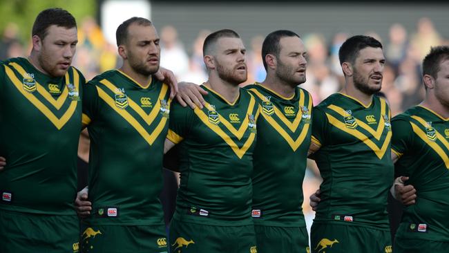 Australian Kangaroos players sing the national anthem.
