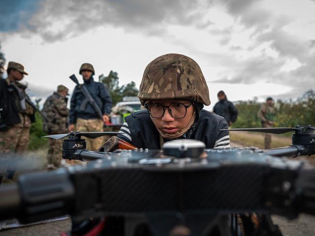 TOPSHOT - This photo taken on December 11, 2023 shows a member of the Mandalay Peopleâs Defense Forces (MDY-PDF) preparing to release a drone near the frontline amid clashes with Myanmar's military in northern Shan State. A squad of Myanmar pro-democracy fighters works quickly to ready drones for an attack on a nearby military base, the latest target in a wave of aerial assaults that has helped turn the war against the junta. (Photo by AFP) / TO GO WITH Myanmar-coup, FOCUS