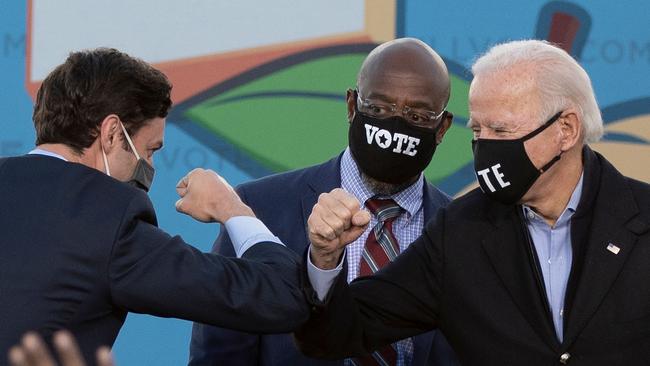 Jon Ossoff (L), Raphael Warnock (C) and US President-elect Joe Biden (R) in Atlanta, Georgia.