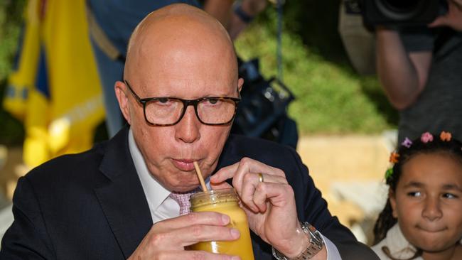 Opposition leader Peter Dutton takes a sip of a drink while meeting a family at a cafe in the seat of Joondalup on May 02, 2025 in Perth. Picture: Dan Peled/Getty Images