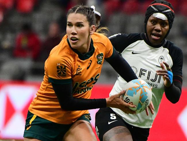 Australiaâs Charlotte Caslick controls the ball during the 2024 HSBC Canada Sevens rugby tournament match between Australia and Fiji at BC Place Stadium in Vancouver, Canada, on February 23, 2024. (Photo by Don MacKinnon / AFP)