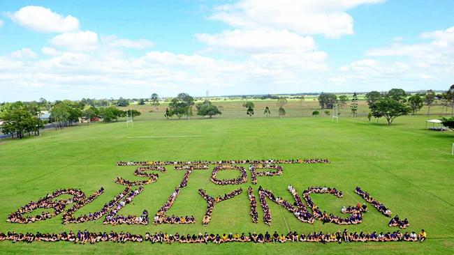 GET THE MESSAGE: North Bundaberg State High School students gather on their school oval to spell out important words ahead of National Day of Action against Bullying and Violence. Picture: Max Fleet BUN190314NSH1