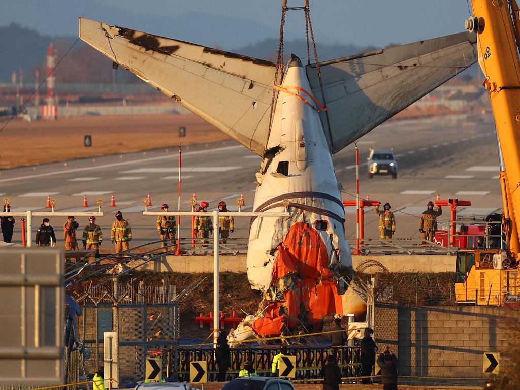 A crane lifts the tail section during the salvage operation of the Jeju Air Boeing 737-800 aircraft. Picture: Yonhap