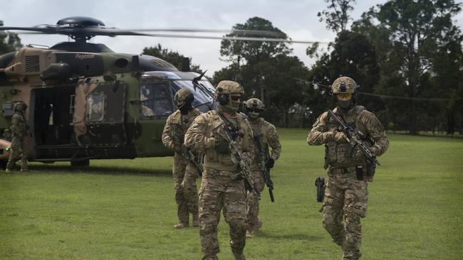 Queensland Police Service Special Emergency Response Team Tactical Operators conduct on-load and off-load drill rehearsals from a Australian Army Multi Role Helicopter (MRH90) aircraft as part of familiarisation training for the 2018 Commonwealth Games. PICTURE: Sgt. W Guthrie, Commonwealth of Australia, Dept. of Defence