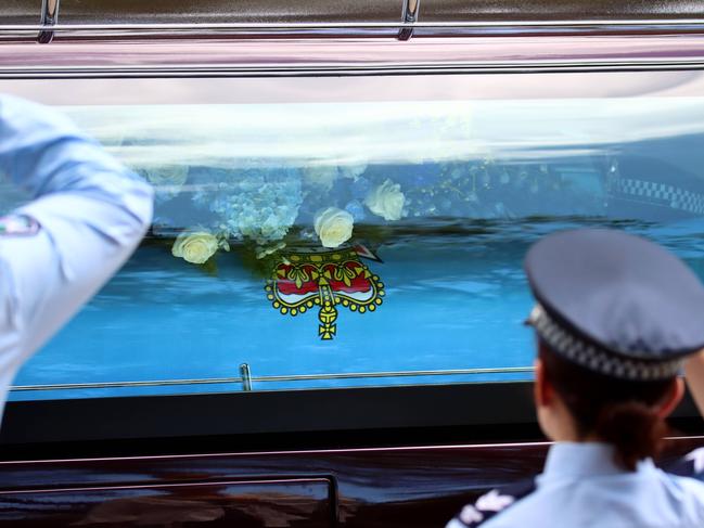 A hearse passes the guard of honour at the memorial service with full police honours for constables Rachel McCrow and Matthew Arnold at Brisbane Entertainment Centre. Picture: David Clark