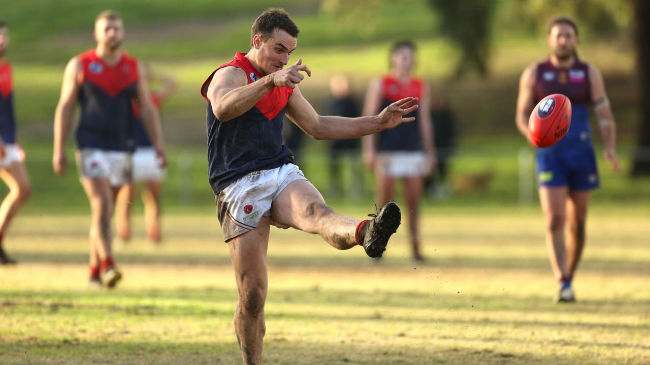 Northern: Diamond Creek’s Jai Norman kicks at goal against Banyule. Picture: Stuart Milligan