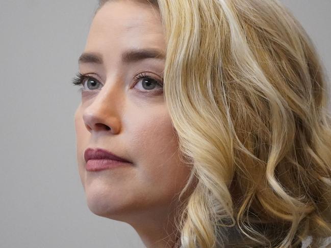 US actress Amber Heard listens in the courtroom at the Fairfax County Circuit Courthouse in Fairfax, Virginia, on May 23, 2022. - US actor Johnny Depp sued his ex-wife Amber Heard for libel in Fairfax County Circuit Court after she wrote an op-ed piece in The Washington Post in 2018 referring to herself as a "public figure representing domestic abuse." (Photo by Steve Helber / POOL / AFP)