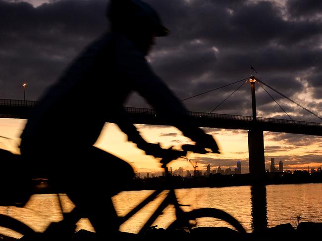 Cyclists make the most of the warm weather before Winter sets in. Melbourne is going for new records of warm weather in May. Picture: Nicole Garmston