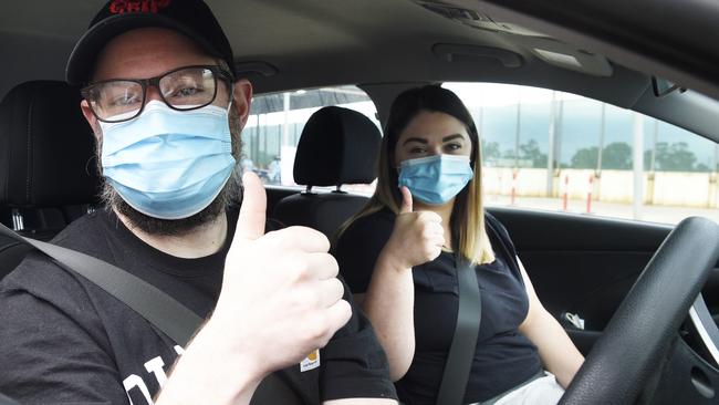 Adan and Kate from Melton give a thumbs-up after receiving their Covid vaccination. Picture: Andrew Henshaw