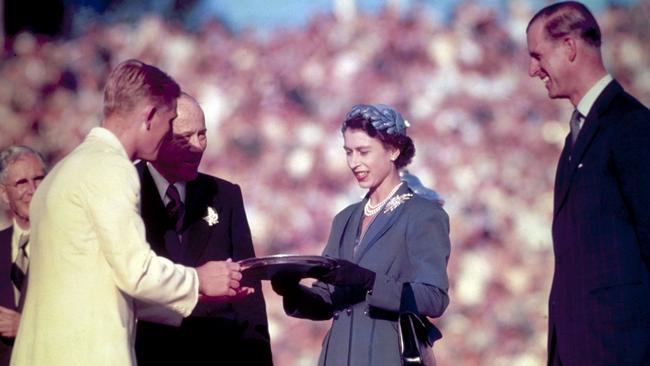 The Queen presents the Silver Salver to Australian tennis champion Lewis Hoad in Kooyong, during her first trip to Australia in 1954. Picture: Getty Images.