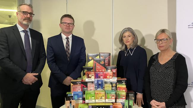 SA Health Protection and Licensing Services Executive Director Dr Chris Lease, Health Minister Chris Picton, Chief Public Health Officer Professor Nicola Spurrier and Sara Driver whose two teenage daughters became addicted to nicotine-laden vapes, in front of seized vapes containing nicotine. Picture: Brad Crouch