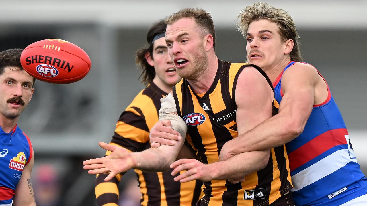 Tom Mitchell of the Hawks is tackled by Bailey Smith of the Bulldogs during the round 23 AFL match between the Hawthorn Hawks and the Western Bulldogs at University of Tasmania Stadium on August 21, 2022 in Launceston, Australia. (Photo by Steve Bell/Getty Images)