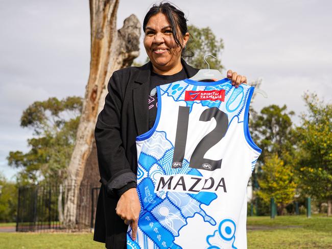 Artist Emma Bamblett with North Melbourne's 2025 Sir Doug Nicholls Round jumper. Picture: NMFC