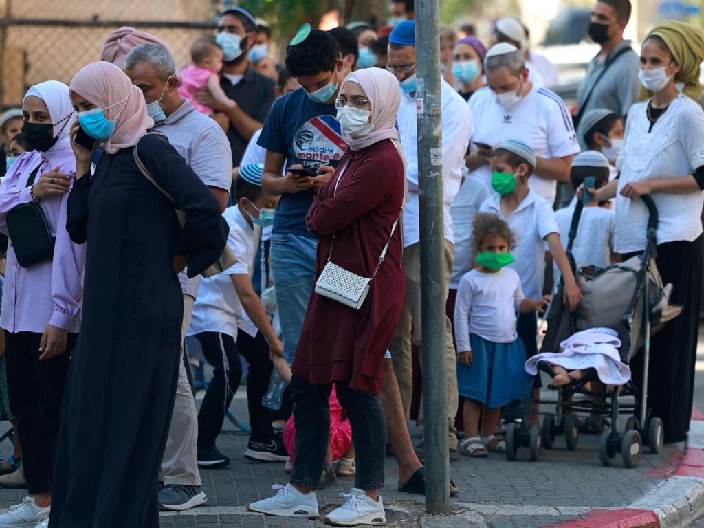 People wait outside Israel's Magen David Adom medical service for a rapid Covid-19 antigenic test on August 8, 2021. Picture: Menahem Kahana/AFP