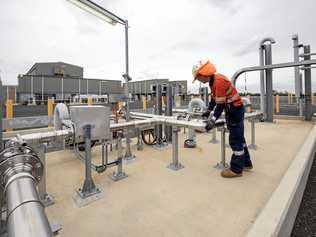 PRICE WAR: A plant operator working at one of APLNG's new gas processing facilities.