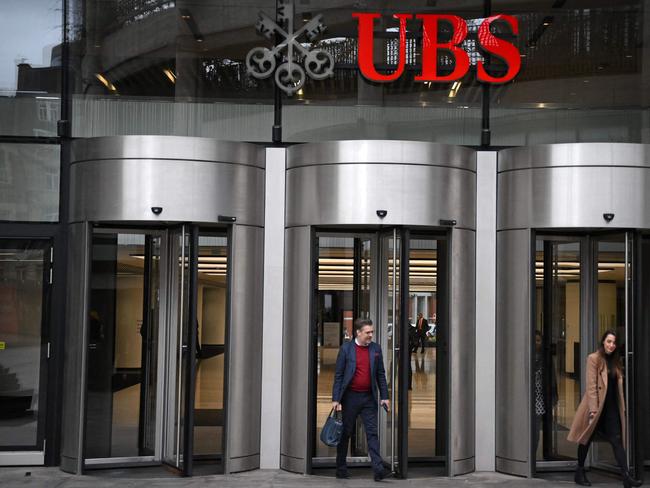 People use the entrance of the London office of Swiss bank UBS in central London. Picture: AFP