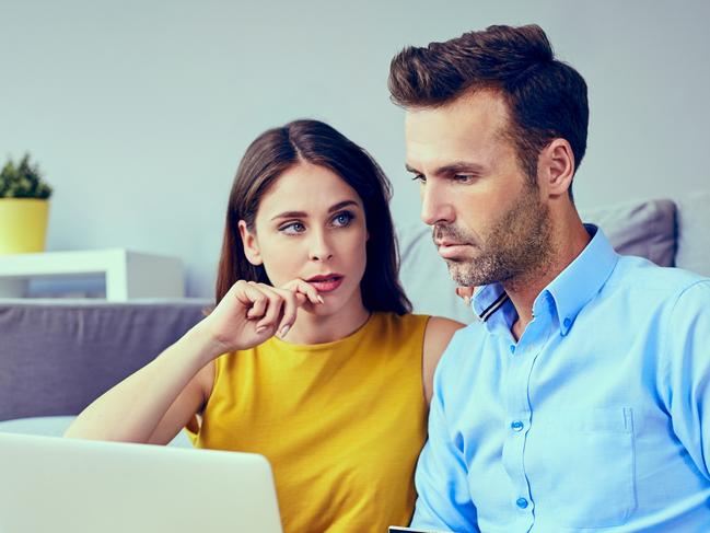 A couple who are stressed about money working out their finances together and assessing their credit card debt. Picture: iStock.