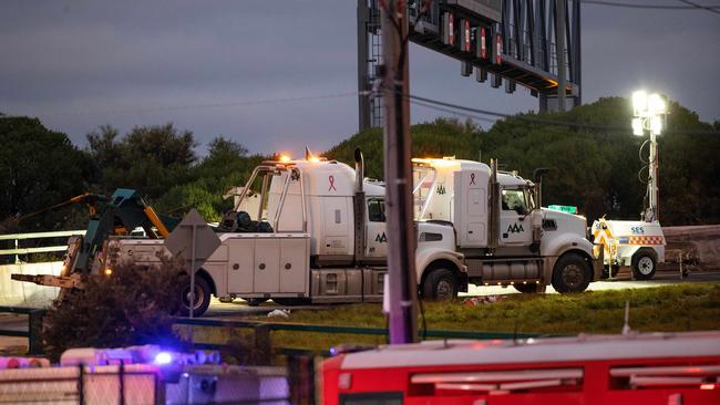 Emergency services were called to reports a truck had crashed into safety barrier on the Western Ring Road and rolled onto its side about 2am. Picture: Mark Stewart