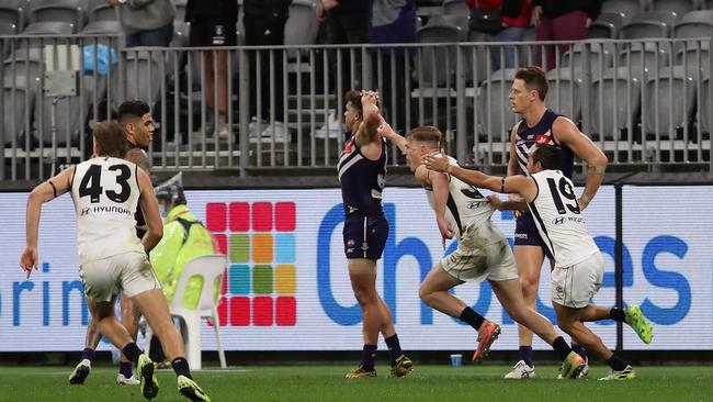 Jack Newnes celebrates the matchwinner as devastated Fremantle players can only watch. Picture: Getty