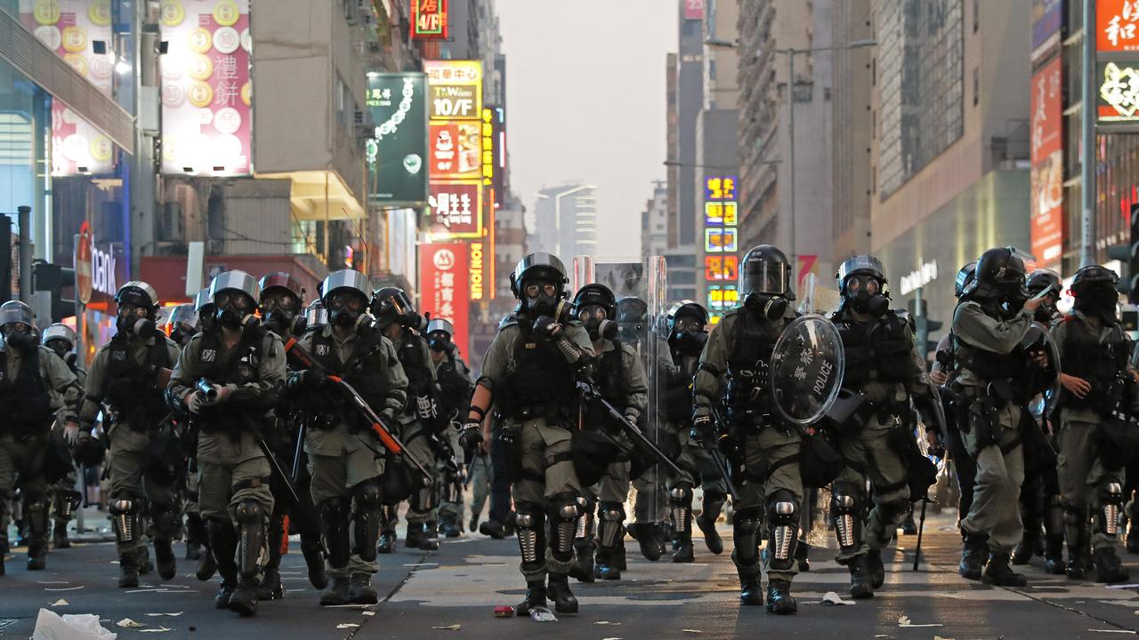 Riot police move forwards as anti-government protesters swarm the streets. Picture: AP