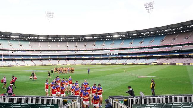 The Lions leave an empty MCG after their Round 1 loss to Hawthorn.