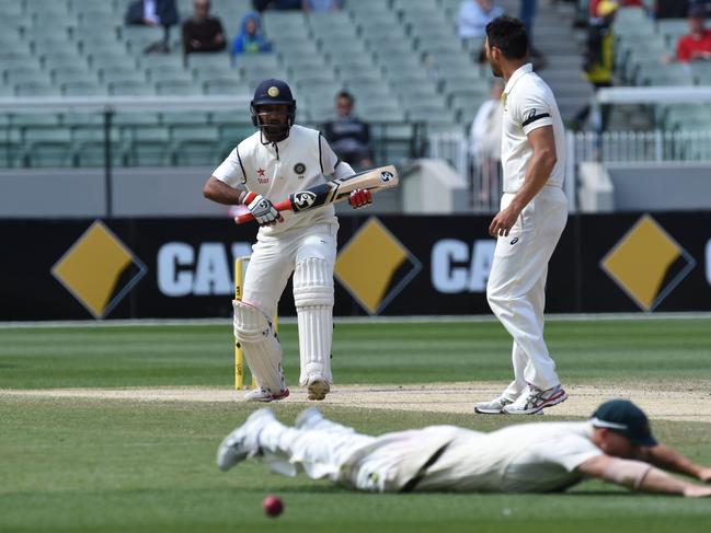 Australian cricketer David Warner (front) dives for a shot from Indian batsman Cheteshwar Pujara on day five of the 2014 Boxing Day Test. Picture: AAP Image/Julian Smith