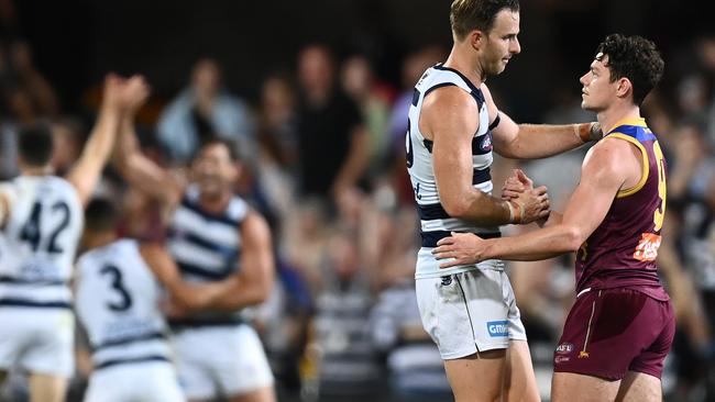 Lachie Henderson consoles Lachie Neale after Geelong’s preliminary final victory.