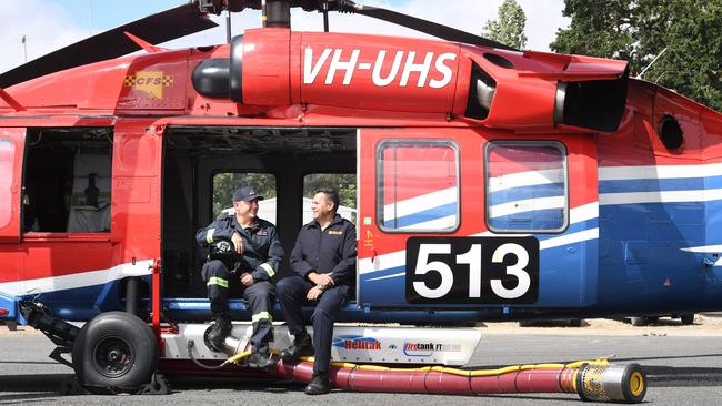 Pilot Scott Summers with the CFS’ manager of aviation operations Nik Stanley inside one of the helicopters. Picture: Tricia Watkinson