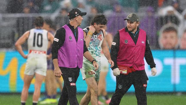 Darcy Byrne-Jones is helped from the field. (Photo by Paul Kane/Getty Images)