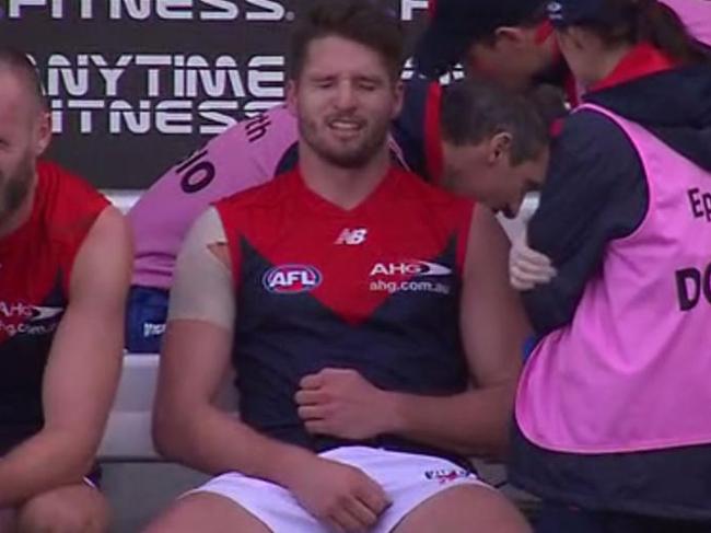 Jesse Hogan cradles a broken collar bone on the bench against North Melbourne in Hobart.