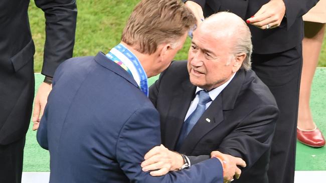 Netherlands' coach Louis van Gaal (L) receives a medal from FIFA President Joseph Blatter.