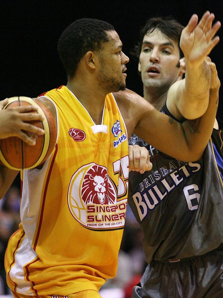 Former Singapore player Marquin Chander and Brisbane Bullets’ great Sam Mackinnon do battle during the Slingers’ NBL stint.