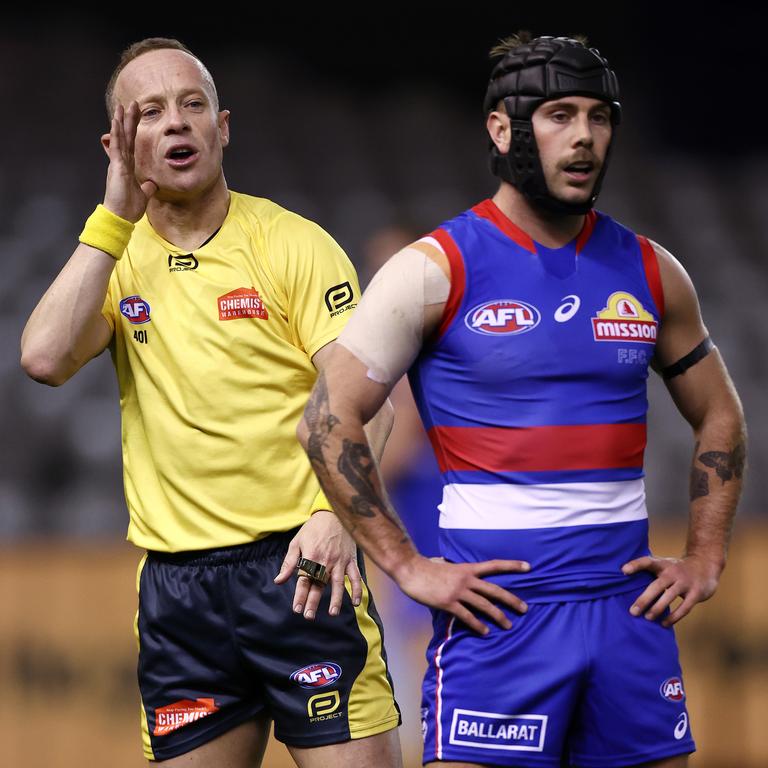 Umpire Ray Chamberlain issues an instruction to Caleb Daniel.