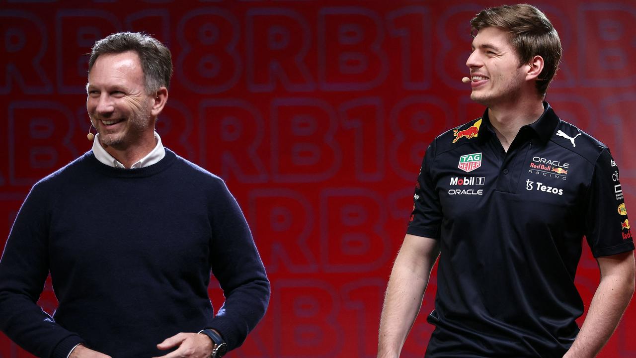 A handout photograph taken on January 26, 2022 and released on February 9, 2022 by Red Bull shows Red Bull Racing's team principal Christian Horner (L) and Formula one Red Bull's Dutch driver Max Verstappen (R) on stage, during the launching presentation of the new Red Bull Racing RB18 car at Red Bull Racing Factory, in Milton Keynes, England. (Photo by Bryn Lennon / Red Bull Content Pool / AFP)\
