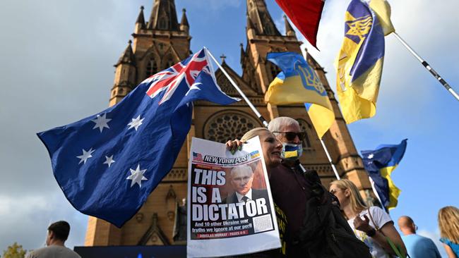 Members of the Ukrainian community in Australia hold flags and placards during a vigil in Sydney, marking the third anniversary of Russia’s invasion of Ukraine. Picture: AFP