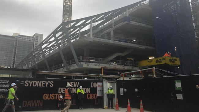 Masked-up builders work on 5 Parramatta Square.