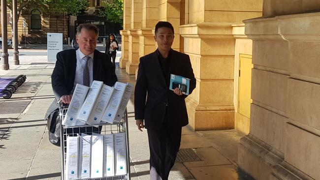 Mr Li, right, with his solicitor Matt Selley, outside the Court of Disputed Returns. Picture: Sean Fewster