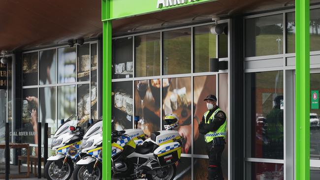 Member of Tasmania Police near the arrivals exit. Picture: Nikki Davis-Jones