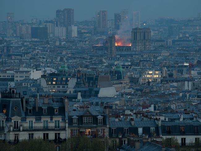 PARIS, FRANCE - APRIL 15: A view of Notre-Dame Cathedral on fire as seen from Montmartre as night falls on April 15, 2019 in Paris, France. A fire broke out on Monday afternoon and quickly spread across the building, collapsing the spire. The cause is yet unknown but officials said it was possibly linked to ongoing renovation work. (Photo by Kay-Paris Fernandes/Getty Images)