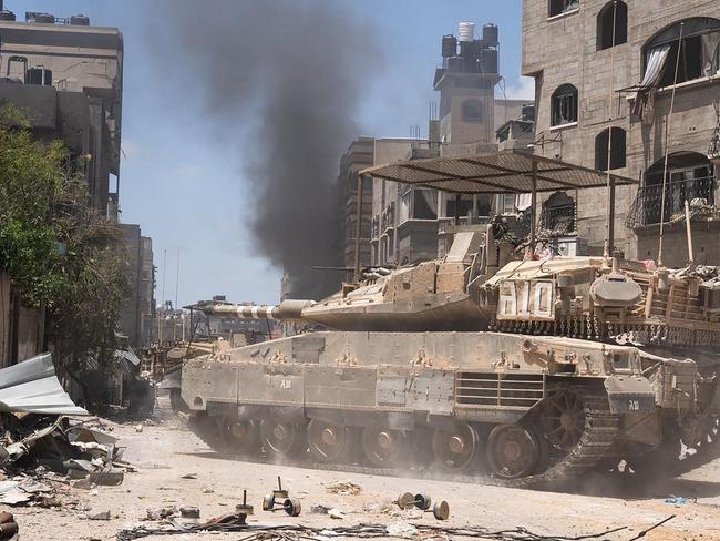 TOPSHOT - This handout picture released by the Israeli army on May 31, 2024 shows an Israeli army tank during operations in the Gaza Strip amid the ongoing conflict between Israel and the Palestinian militant group Hamas. (Photo by Israeli Army / AFP) / === RESTRICTED TO EDITORIAL USE - MANDATORY CREDIT "AFP PHOTO / Handout / Israeli Army' - NO MARKETING NO ADVERTISING CAMPAIGNS - DISTRIBUTED AS A SERVICE TO CLIENTS ==