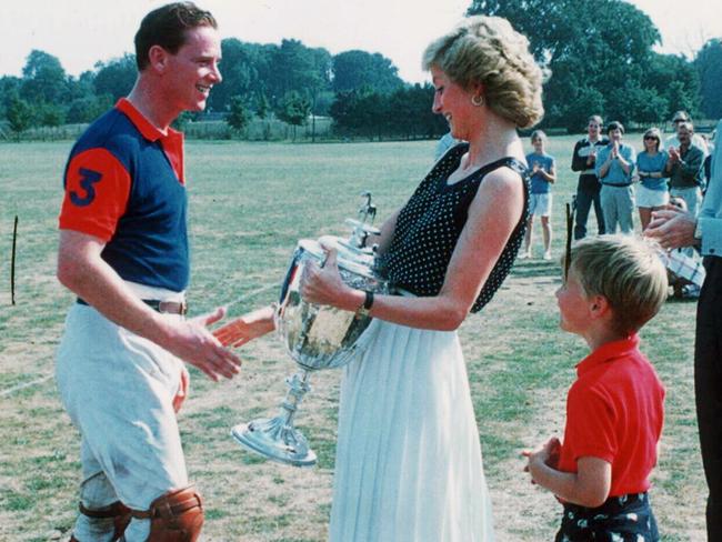 Diana Princess of Wales presenting Major James Hewitt with a trophy, while the young Prince William looks on.