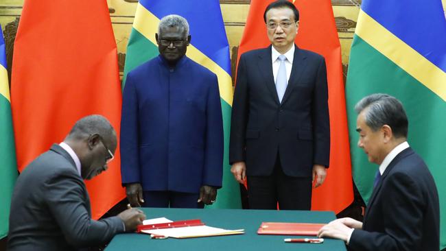 Solomon Islands Prime Minister Manasseh Sogavare, Solomon Islands Foreign Minister Jeremiah Manele, Chinese Premier Li Keqiang and Chinese State Councillor and Foreign Minister Wang Yi attend a signing ceremony at the Great Hall of the People on October 9, 2019 in Beijing, China. (Photo by Thomas Peter-Pool/Getty Images)